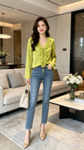 Lime Green Satin Ruffle Blouse - model with jeans and white bag living room