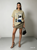 Beige So Ned Graphic Oversized Tee - model with mini skirt and strappy heels standing