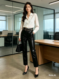Black Faux Leather Tapered Trousers - model with white blouse and black heels in office