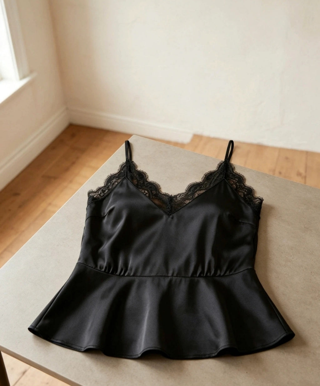 Black Satin Lace Peplum Cami Top - flat lay on bench